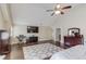 Spacious primary bedroom featuring a ceiling fan, TV, rug, and en-suite bathroom at 5040 Fawn Valley Dr, Loganville, GA 30052