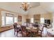 The formal dining room features a large window, hardwood floors, and a stylish chandelier at 5040 Fawn Valley Dr, Loganville, GA 30052