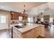 Open kitchen with a large island, built-in cabinetry, tile countertops, and a view to the dining area at 5040 Fawn Valley Dr, Loganville, GA 30052