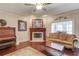 Cozy living room boasts a fireplace, dark hardwood floors and comfortable seating, perfect for relaxing at 5040 Fawn Valley Dr, Loganville, GA 30052