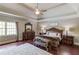 The main bedroom features trey ceilings, hardwood floors, and a large window for natural light at 5040 Fawn Valley Dr, Loganville, GA 30052