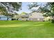 Spacious and lush backyard with a home featuring a covered patio, perfect for relaxing and entertaining at 130 Mimosa Dr, Fayetteville, GA 30214
