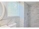 Modern bathroom featuring a shower with marble-like tiled walls and a window at 130 Mimosa Dr, Fayetteville, GA 30214