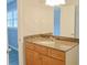Bathroom featuring granite vanity, framed mirror, and wood cabinets at 130 Mimosa Dr, Fayetteville, GA 30214