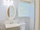 Modern bathroom featuring a shower with marble-like tiled walls and a window at 130 Mimosa Dr, Fayetteville, GA 30214