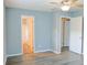 Comfortable bedroom with wood-look floors, access to bathroom, and bright doorway at 130 Mimosa Dr, Fayetteville, GA 30214