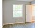 Sunlit bedroom with large window overlooking yard and door leading to another room at 130 Mimosa Dr, Fayetteville, GA 30214