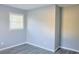 Bedroom showing light blue walls, modern flooring, and a bright window at 130 Mimosa Dr, Fayetteville, GA 30214