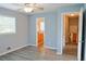 Well-lit bedroom with wood-look floors, adjacent bathroom, and convenient access to other rooms at 130 Mimosa Dr, Fayetteville, GA 30214