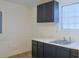 This is a laundry room or kitchenette with dark cabinets, sink and a window at 130 Mimosa Dr, Fayetteville, GA 30214