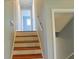 Carpeted stairway with white walls and light wood banister at 130 Mimosa Dr, Fayetteville, GA 30214