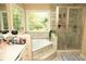 Elegant bathroom with double sinks, soaking tub, and separate shower area at 1473 Wildwood Way, Hampton, GA 30228