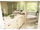Beautiful bathroom featuring double sinks, a tub, and a glass-enclosed shower stall at 1473 Wildwood Way, Hampton, GA 30228
