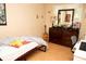 Bedroom featuring a bed, dresser, guitar, desk, and hardwood floors at 1473 Wildwood Way, Hampton, GA 30228