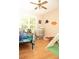 Bedroom with hardwood floors, dinosaur decorations, and a window at 1473 Wildwood Way, Hampton, GA 30228