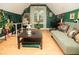 Bonus room with hardwood floors, a couch, and hanging chair at 1473 Wildwood Way, Hampton, GA 30228