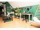 Bonus room with hardwood floors, hanging chair, and green walls at 1473 Wildwood Way, Hampton, GA 30228