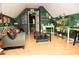 Bonus room with hardwood floors, comfortable couch and green walls at 1473 Wildwood Way, Hampton, GA 30228