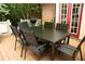 A six-chair dining set with natural gas grill sits on this home's wooden deck at 1473 Wildwood Way, Hampton, GA 30228