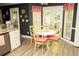 Adorable dining area with a round table and charming red and white accents at 1473 Wildwood Way, Hampton, GA 30228