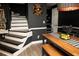 Stylish dining area featuring a modern table, unique wall art, and a view of the staircase, creating an inviting space at 1473 Wildwood Way, Hampton, GA 30228
