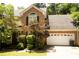 Charming brick home with a well-maintained lawn and mature landscaping, showcasing curb appeal at 1473 Wildwood Way, Hampton, GA 30228