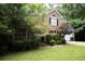 Beautiful two-story brick home with lush greenery and a two-car garage, exuding a welcoming atmosphere at 1473 Wildwood Way, Hampton, GA 30228