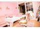 Cozy home office with a comfortable chair, a modern desk, and soft pink accents, designed for creativity at 1473 Wildwood Way, Hampton, GA 30228