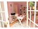 Bright and airy home office with french doors, a stylish desk, and shelving, creating a productive workspace at 1473 Wildwood Way, Hampton, GA 30228