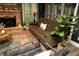 Cozy living room features a stacked stone fireplace and stylish decor accents at 1473 Wildwood Way, Hampton, GA 30228