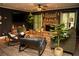 Charming living room with stone fireplace, TV, and comfortable rocking chairs at 1473 Wildwood Way, Hampton, GA 30228