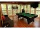 The spacious game room boasts a pool table, comfortable seating, and natural light at 1473 Wildwood Way, Hampton, GA 30228