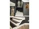 Elegant stairway with black and white accents, complemented by stylish wall decor and modern lighting at 1473 Wildwood Way, Hampton, GA 30228