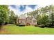 Beautiful brick home with a spacious backyard, mature trees, and manicured landscaping at 35 Inverleigh Row, Covington, GA 30014