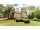 Brick exterior with a deck and a well manicured lawn at 35 Inverleigh Row, Covington, GA 30014