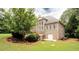 Back exterior featuring a brick home, deck, large yard, and private basement entrance at 35 Inverleigh Row, Covington, GA 30014