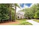 Exterior shot of a brick home with an inviting circular driveway lined with manicured landscaping at 35 Inverleigh Row, Covington, GA 30014