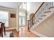 Bright foyer featuring hardwood floors, staircase, and a front door with decorative glass at 35 Inverleigh Row, Covington, GA 30014