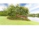 Stunning lake view showcasing a covered dock, grassy shoreline, and mature trees at 35 Inverleigh Row, Covington, GA 30014