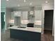 Spacious kitchen with a center island, white cabinets, stainless steel appliances, and views into the dining area at 3032 Farm Tract Trl, Woodstock, GA 30189