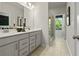 Bathroom features a double sink vanity, tile floor, and glass enclosed shower at 55 Peeples Dr, Lawrenceville, GA 30046