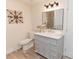 Stylish bathroom with vanity, marble countertop, and decorative mirror at 6914 N Baggett Rd, Douglasville, GA 30134