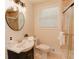 Modern bathroom with tile flooring, vanity with round mirror, and shower with glass doors at 6914 N Baggett Rd, Douglasville, GA 30134