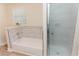 Clean bathroom with bathtub, shower, and marble tiled backsplash at 6914 N Baggett Rd, Douglasville, GA 30134