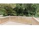 View of a wooden deck overlooking a backyard with lush greenery at 6914 N Baggett Rd, Douglasville, GA 30134