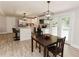 Open-concept kitchen with white cabinets, stainless steel appliances, an island, and a dining area at 6914 N Baggett Rd, Douglasville, GA 30134
