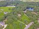 Stunning aerial view of a home with a large lot, nestled among trees and near a serene lake at 2010 Bennett Rd, Grayson, GA 30017