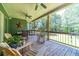Relaxing screened-in back porch with rocking chairs and wooded views at 2010 Bennett Rd, Grayson, GA 30017