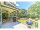 Covered back porch with wood deck, ceiling fans, grill, and view of the wooded backyard at 2010 Bennett Rd, Grayson, GA 30017