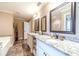 Elegant bathroom featuring double sinks, granite countertops and tile floor at 2010 Bennett Rd, Grayson, GA 30017